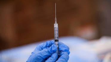 FILE PHOTO: A syringe is filled with a dose of Pfizer's coronavirus disease (COVID-19) vaccine at a pop-up community vaccination center at the Gateway World Christian Center in Valley Stream, New York, U.S., February 23, 2021. REUTERS/Brendan McDermid/File Photo