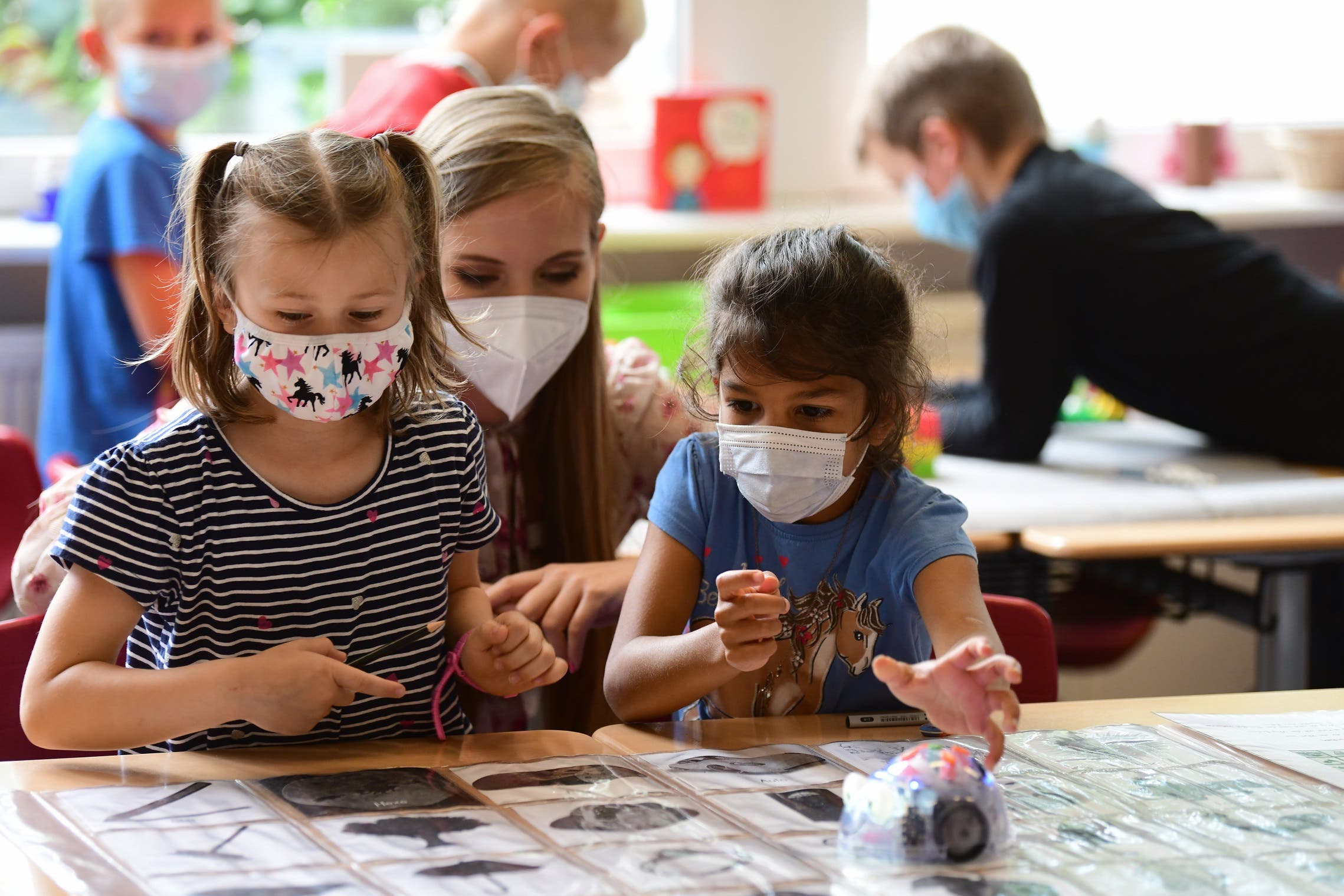 Two girls wearing masks in a German school