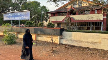 Ayesha Imthiaz, 21, a Muslim college student, wearing a hijab, walks past her college in Udupi, Karnataka state, India, February 11, 2022. Picture taken February 11, 2022. (Reuters)