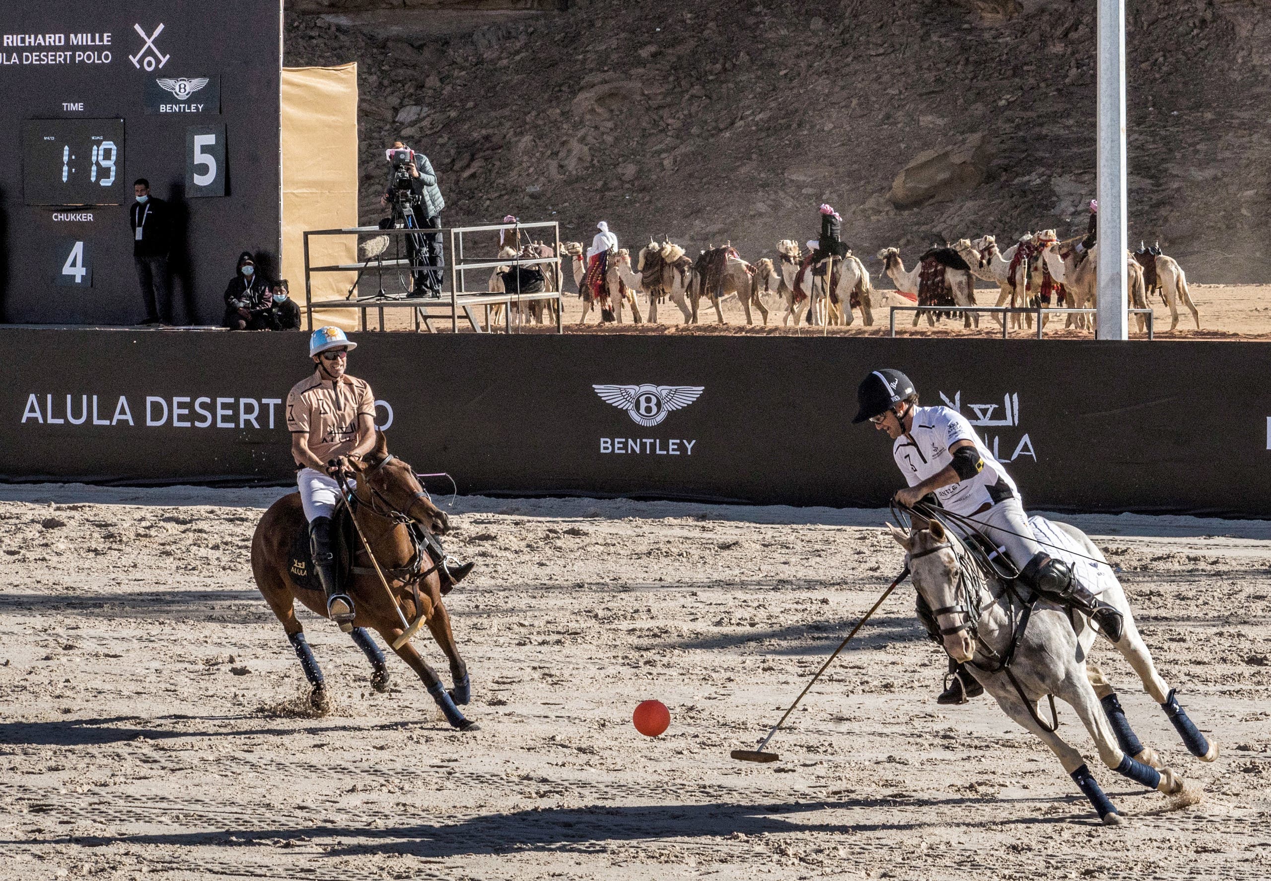 This handout image provided by AlUla Desert Polo 2022 championship shows French entrepreneur, and Polo player Jean-Francois Decaux (R) taking part in the tournament in Saudi Arabia's northwestern city of al-Ula. (AFP)