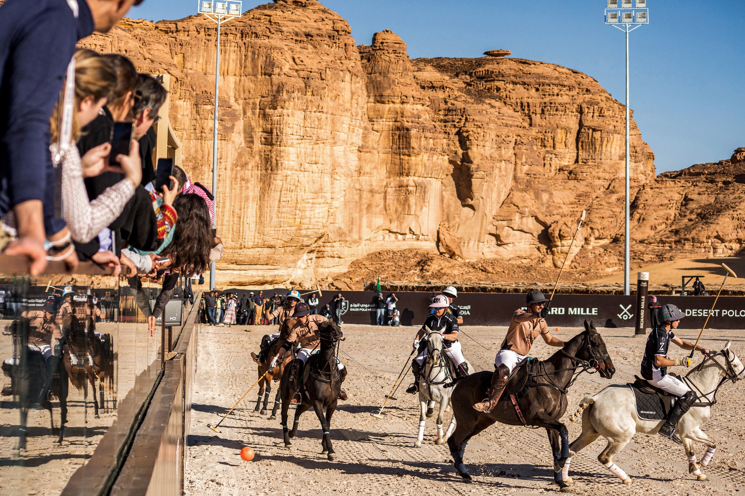 This handout image provided by AlUla Desert Polo 2022 championship shows spectators watching players during the tournament in Saudi Arabia's northwestern city of al-Ula on February 11, 2022. (AFP)