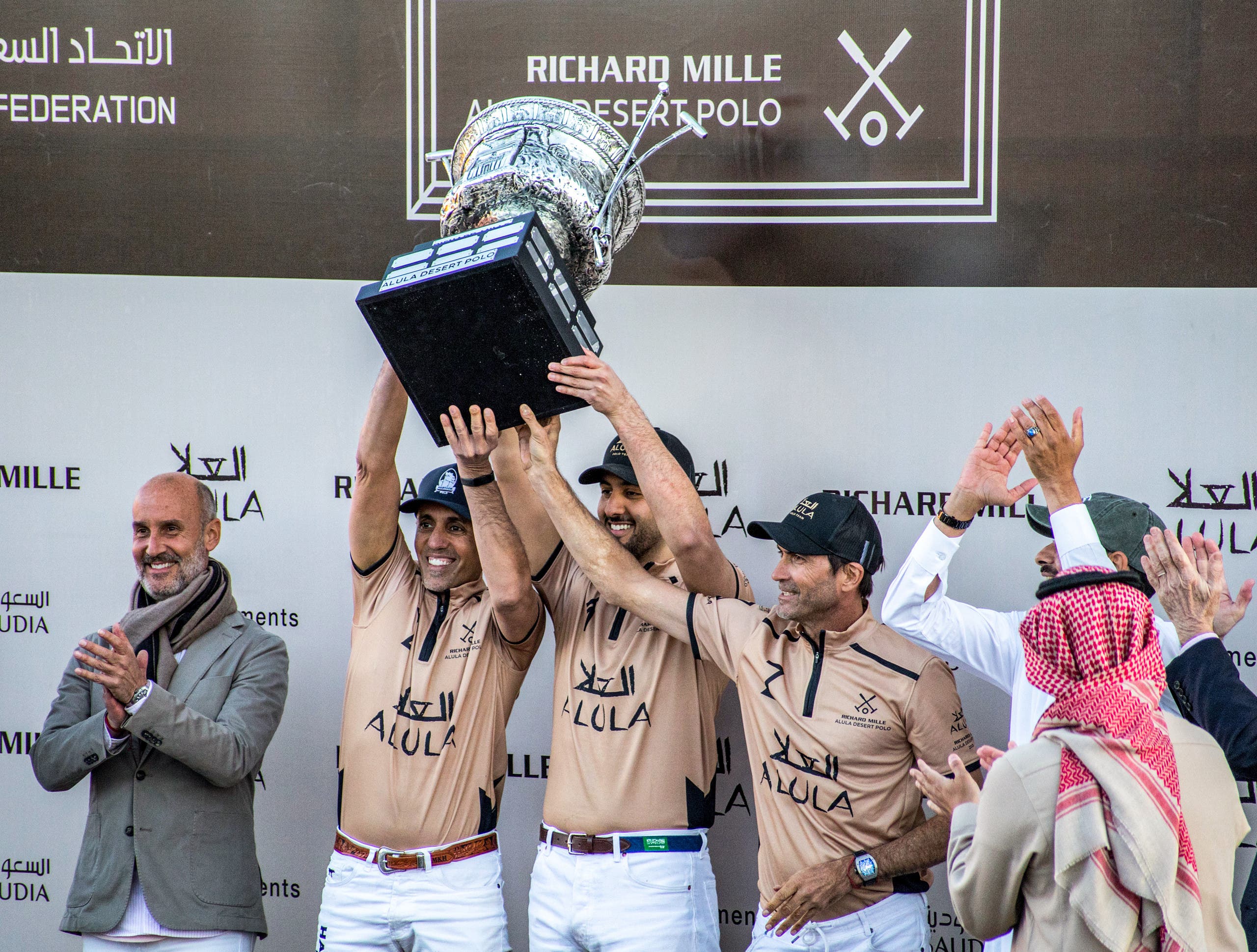 This handout image provided by AlUla Desert Polo 2022 championship shows members of the Saudi polo team celebrating with their winning trophy in Saudi Arabia's northwestern city of al-Ula on February 11, 2022. (AFP)