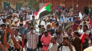 Sudanese protesters march during a demonstration calling for civilian rule and denouncing the military administration, in the capital Khartoum's twin city of Umdurman, on February 14, 2022. (AFP)