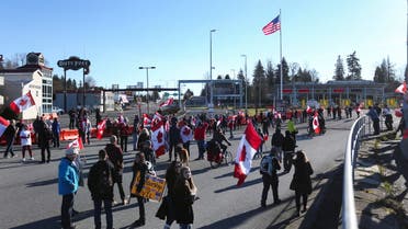 Protesters approach the Canada/US border as truckers and supporters continue to protest coronavirus disease (COVID-19) vaccine mandates, near the Canada and US border crossing in Surrey, British Columbia, Canada, February 12, 2022. (Reuters)