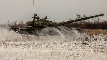  A tank of the Russian armed forces drives during military exercises in the Leningrad Region, Russia, in this handout picture released on February 14, 2022. (Reuters)