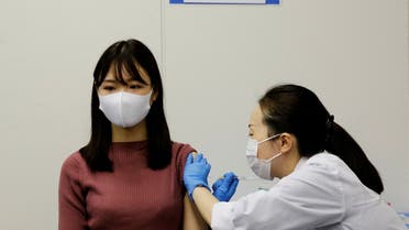 FILE PHOTO: A staff of All Nippon Airways (ANA) receives a dose of the Moderna coronavirus disease (COVID-19) vaccine at the company's facility at Haneda airport in Tokyo, Japan June 14, 2021. REUTERS/Kim Kyung-Hoon/File Photo