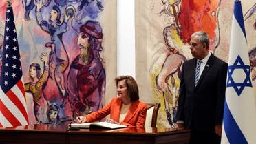 US House Speaker Nancy Pelosi signs the guest book at the Knesset, Israel's parliament, in Jerusalem, February 16, 2022. (Reuters)