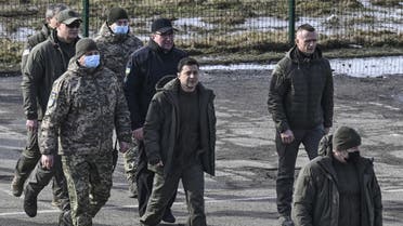 Ukrainian President Volodymyr Zelensky (C) arrives to attend a military drill outside the city of Rivne, northern Ukraine on February 16, 2022. (AFP)
