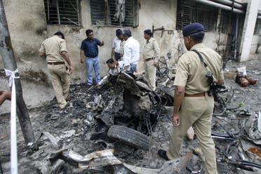 This file photo taken on July 27, 2008 shows Indian forensic experts collecting evidence from a blast site outside the Civil Hospital in Ahmedabad following a series of bombings the day before which killed dozens. (AFP)