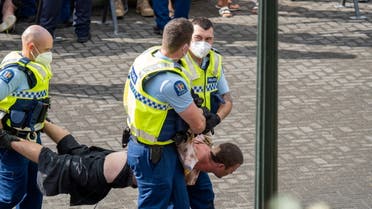A man is detained by New Zealand police as people gather outside the Parliament building to protest against coronavirus disease (COVID-19) vaccination mandates, in Wellington, New Zealand, February 10, 2022 in this picture obtained from social media. February 10, 2022. (Reuters)