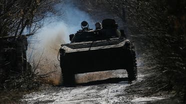 Ukrainian service members ride an infantry fighting vehicle on the front line near the village of Zaitseve in the Donetsk region, Ukraine February 19, 2022. REUTERS/Gleb Garanich