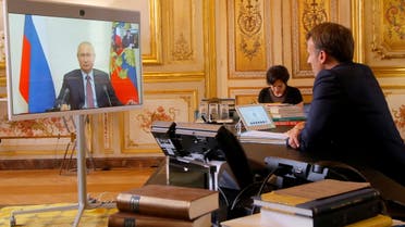 FILE PHOTO: French President Emmanuel Macron talks with Russian President Vladimir Putin during a video conference at the Elysee Palace in Paris, France, June 26, 2020. Michel Euler/Pool via REUTERS/File Photo
