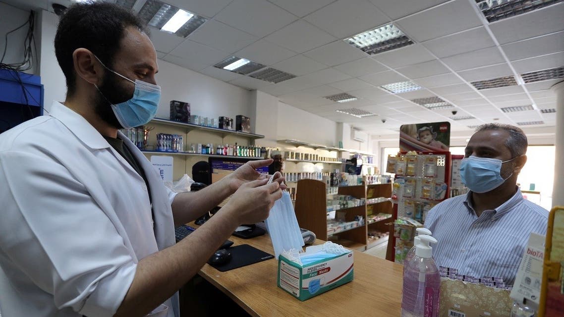 A man wearing a protective mask, buys masks from a pharmacy, after the government lifted coronavirus lockdown restrictions, in Riyadh, Saudi Arabia. (Reuters)