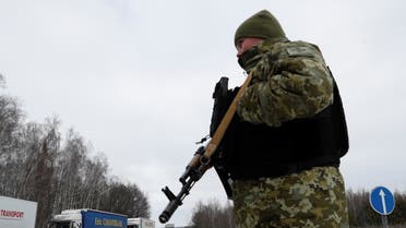 A member of the Ukrainian State Border Guard Service keeps watch at the Senkivka checkpoint near the border with Belarus and Russia in the Chernihiv region, Ukraine, on February 16, 2022. (Reuters)