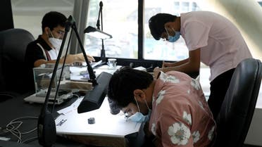 Buyers inspect diamonds at Rapaport Auctions in the Dubai Diamond Exchange in Dubai, United Arab Emirates, on September 24, 2020. (Reuters)