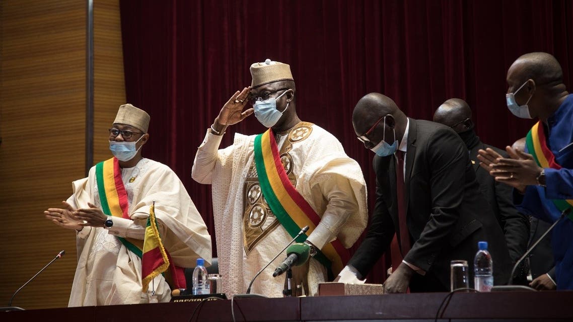 President of the National Transitional Council (NTC), Malick Diaw (C) salutes members of the council during a meeting to vote on a revised charter in Bamako on February 21, 2022. (AFP)