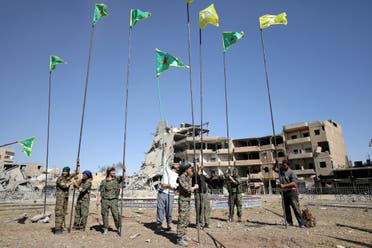 Syrian Democratic Forces place flags at Naim Square after liberating Raqqa, Syria. October 18, 2017. (Reuters)