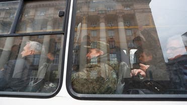 Men mobilized for military service sit inside a bus, after Russian President Vladimir Putin authorized a military operation in eastern Ukraine, in the separatist-controlled city of Donetsk, Ukraine February 21, 2022. (Reuters)