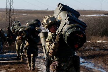 Service members of the Ukrainian Armed Forces carry weapons during military drills at a firing ground in the Donetsk region, Ukraine, February 15, 2022. Picture taken February 15, 2022. (Reuters)