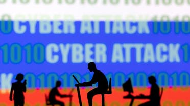 Figurines with computers and smartphones are seen in front of the words Cyber Attack, binary codes and the Russian flag, in this illustration taken February 15, 2022. (Reuters)