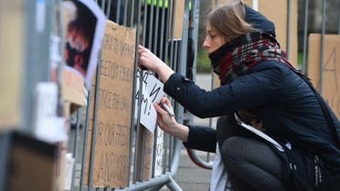 A protester leaves a message on railings outside the Russian Consulate in Edinburgh on February 25, 2022 as protests take place against Russia's invasion of Ukraine. (AFP)