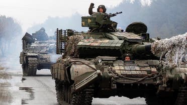Ukrainian servicemen in tanks towards the front line with Russian forces in the Lugansk region, Feb. 25, 2022. (AFP)