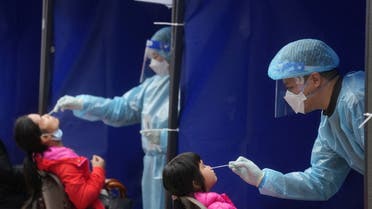 FILE PHOTO: Medical workers take swab samples from residents at a community nucleic acid testing centre for the coronavirus disease (COVID-19) at Sha Tin district, in Hong Kong, China, February 7, 2022. (File Photo: Reuters)