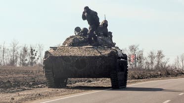 Ukrainian army soldiers are seen on an armoured vehicle, after Russian President Vladimir Putin authorised a military operation, in eastern Ukraine, in Kharkiv region, Ukraine February 24, 2022. REUTERS/Antonio Bronic