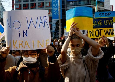 Protesters hold banners during a rally against Russia's invasion of Ukraine, in Tokyo, Japan, February 26, 2022.(Reuters)
