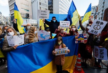 Ukrainians residing in Japan hold placards and flags during a protest rally denouncing on Russia over its actions in Ukraine, near Russian embassy in Tokyo, Japan February 23, 2022. REUTERS/Issei Kato