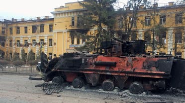 A destroyed Ukrainian armored personnel carrier vehicle is seen in front of a school which, according to local residents, was on fire after shelling, as Russia's invasion of Ukraine continues, in Kharkiv, Ukraine February 28, 2022. (Reuters)