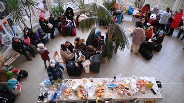 Volunteers serve food and drinks to Ukrainian refugees at the temporary refugee center in a local primary school at Tiszabecs, eastern Hungary on February 28, 2022. (AFP)