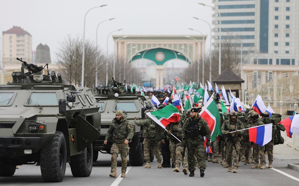 Service members march along a street following head of the Chechen Republic Ramzan Kadyrov's address, dedicated to a military conflict in Ukraine, in Grozny, Russia February 25, 2022. (Reuters)