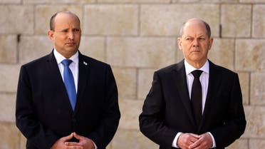 German Chancellor Olaf Scholz stands next to Israeli Prime Minister Naftali Bennett during a state visit to Yad Vashem World Holocaust Remembrance Center in Jerusalem, March 2, 2022. (Reuters)
