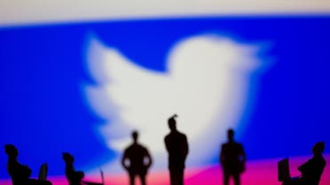 Small toy figures are seen in front of Twitter logo and Russian flag colours in this illustration picture taken March 15, 2021. REUTERS/Dado Ruvic/Illustration