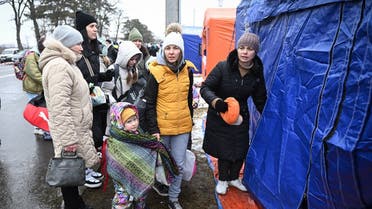 Women and children, refugees coming from Ukraine enter a shelter tent at the Ukrainian-Romanian border in Siret on March 02, 2022. (AFP)
