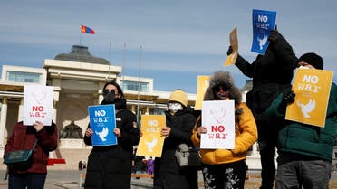 Demonstrators hold signs at a rally in support of Ukraine following Russia's invasion of the country, near the Government Palace on Sukhbaatar Square in Ulaanbaatar, Mongolia March 1, 2022. (Reuters)