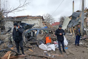 Three men stand in the rubble in Zhytomyr on March 02, 2022, following a Russian bombing the day before. (AFP)