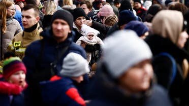 People gather outside the temporary accommodation centre after fleeing Russian invasion of Ukraine, in Korczowa, Poland, March 3, 2022. (AFP)