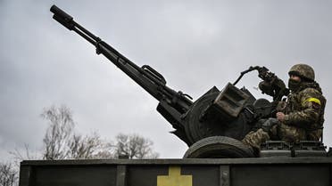 An Ukrainian soldier keeps position sitting on a ZU-23-2 anti-aircraft gun at a frontline, northeast of Kyiv on March 3, 2022. (AFP)