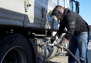 A truck driver fills his tank at a LNG (Liquefied Natural Gas) filling station, after Russia's invasion of Ukraine, in Soltau, Germany, March 2, 2022. (Reuters)