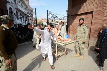 People move an injured on a stretcher after a bomb blast in a mosque during Friday prayers, at a hospital in Peshawar, Pakistan, March 4, 2022. (Reuters)
