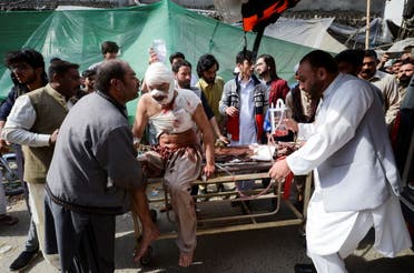 People move an injured on a stretcher, after a bomb blast in a mosque during Friday prayers, at a hospital in Peshawar, Pakistan, March 4, 2022. (Reuters)