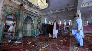 People stand amid the damages at the prayer hall after a bomb blast inside a mosque during Friday prayers in Peshawar, Pakistan, March 4, 2022. (Reuters)