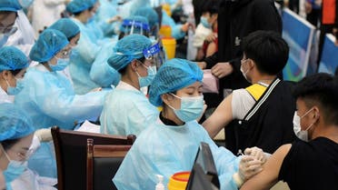 Medical workers inoculate students with the vaccine against the coronavirus at a university in Qingdao, Shandong province, China. (Reuters)