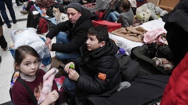 People sit on camp beds at a refugee reception center, as Russia's invasion of Ukraine continues, at the Ukrainian-Polish border crossing in Korczowa, Poland March 5, 2022. Olivier Douliery/Pool via REUTERS