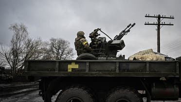 An Ukrainian soldier keeps position sitting on a ZU-23-2 anti-aircraft gun at a frontline, northeast of Kyiv on March 3, 2022. (AFP)