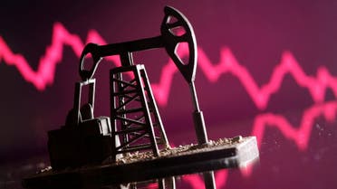 A 3D-printed oil pump jack is seen in front of displayed stock graph in this illustration picture, April 14, 2020. (Reuters)