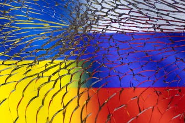 Ukraine and Russian flags are seen through broken glass in this illustration taken March 1, 2022. (Reuters)