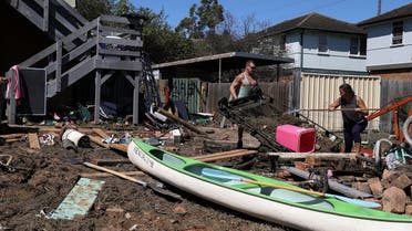 File photo of local residents clean up debris in the aftermath of the area getting inundated with floodwaters following prolonged rains and a severe weather event in the suburb of Windsor in Sydney, Australia. (Reuters)